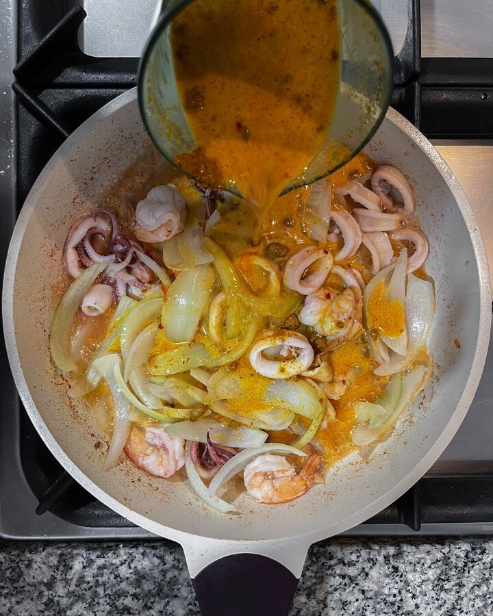Add the mixed savory egg sauce over the finely chopped onion and continue stirring until the egg firms up.