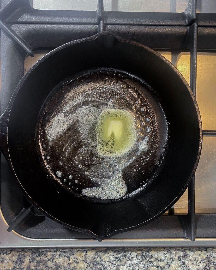 Coat a pan with butter or oil and heat to medium-high.