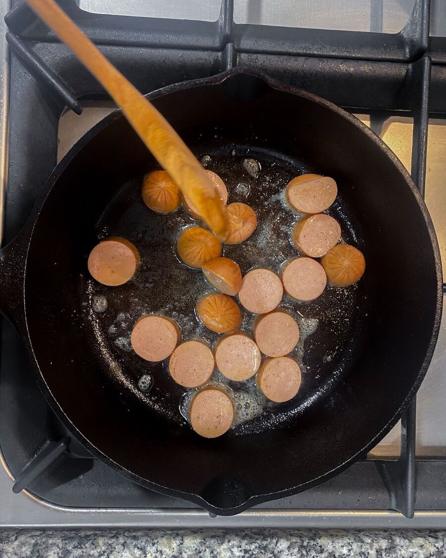 Once the butter is melted, cut sausage into bite-size pieces, cook in the pan for a few minutes, and set aside in the pan.