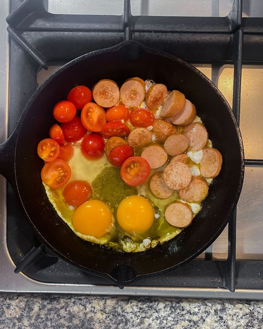 Crack eggs into the pan, season lightly with salt and pepper, and cook until the eggs are set.