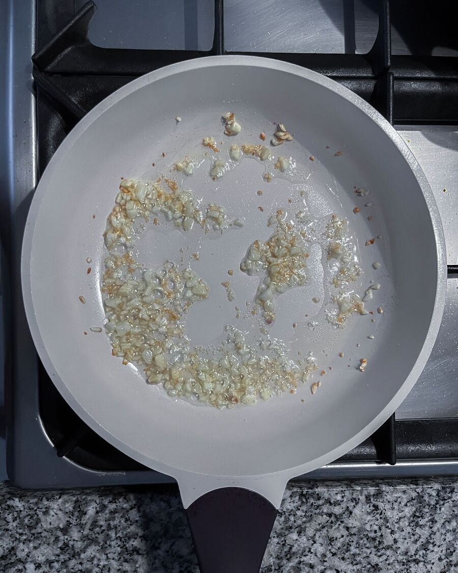 Set a pan to medium-high heat, add minced garlic, and stir until fragrant.