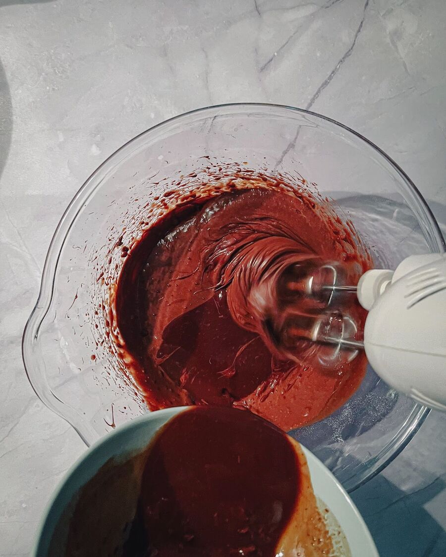 Once the melted butter and chocolate chips have cooled, add them to the mixture and beat on medium speed for about 3 minutes.