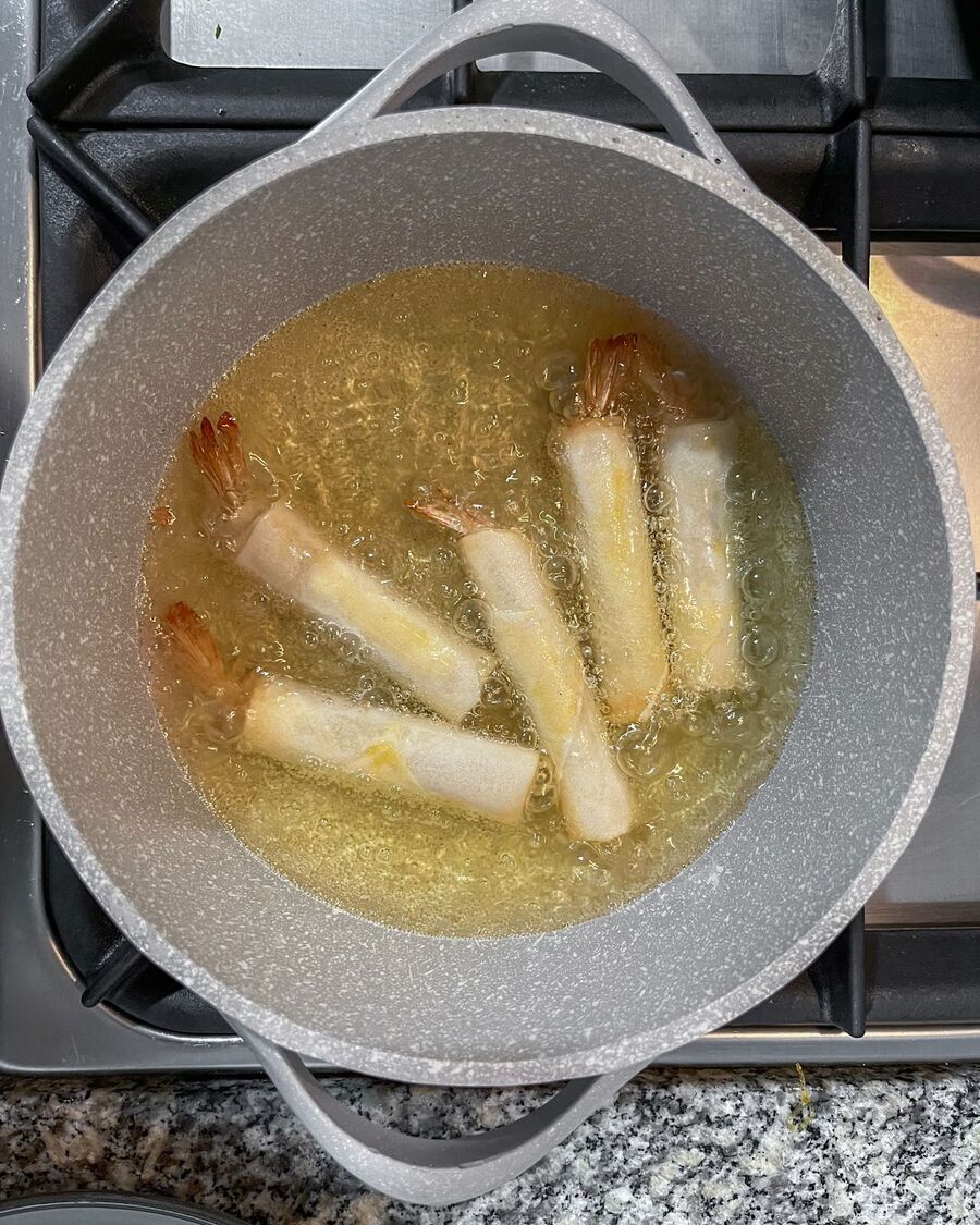 Heat a pot or pan with cooking oil to a depth of about 4 inches over high heat. When the oil is hot, drop the shrimp spring rolls into the pot.
