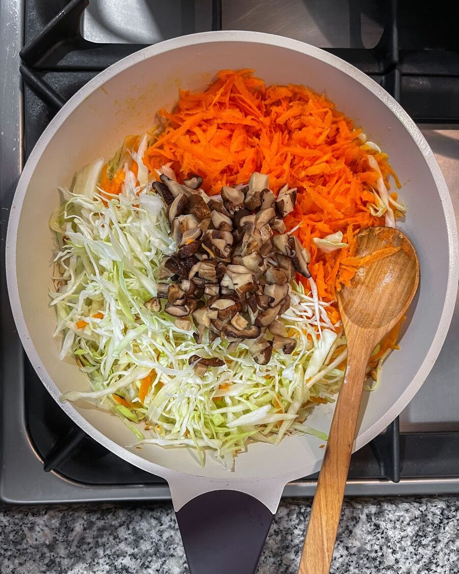 Add the cabbage, carrots, and mushrooms and stir them for a few minutes until all the vegetables are soft.