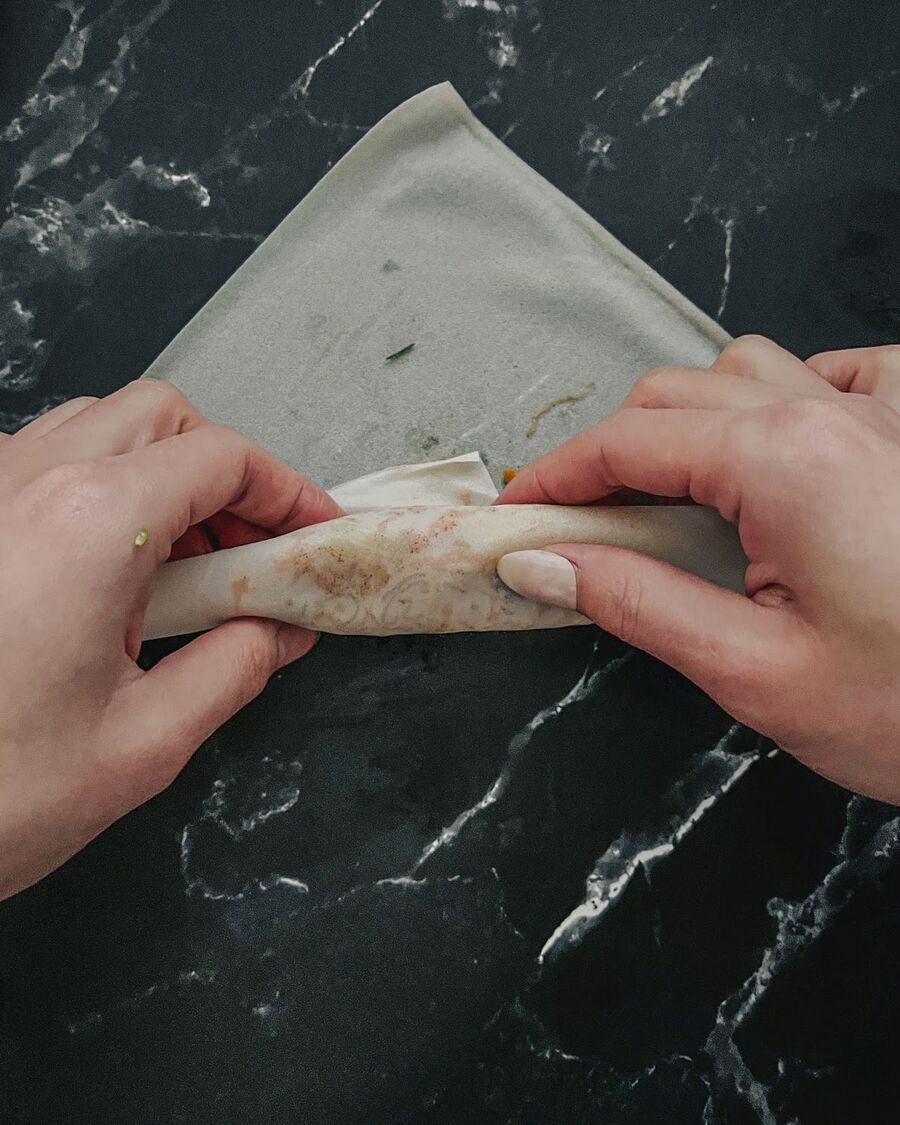 Tuck the wrapper from the bottom over the filling once.
