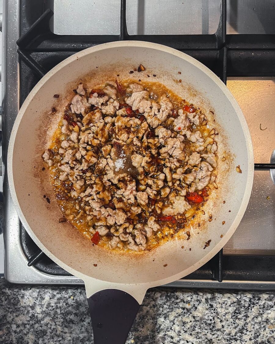 Stir the minced pork continuously, then add oyster sauce, soy sauce, dark soy sauce, fish sauce, and sugar.