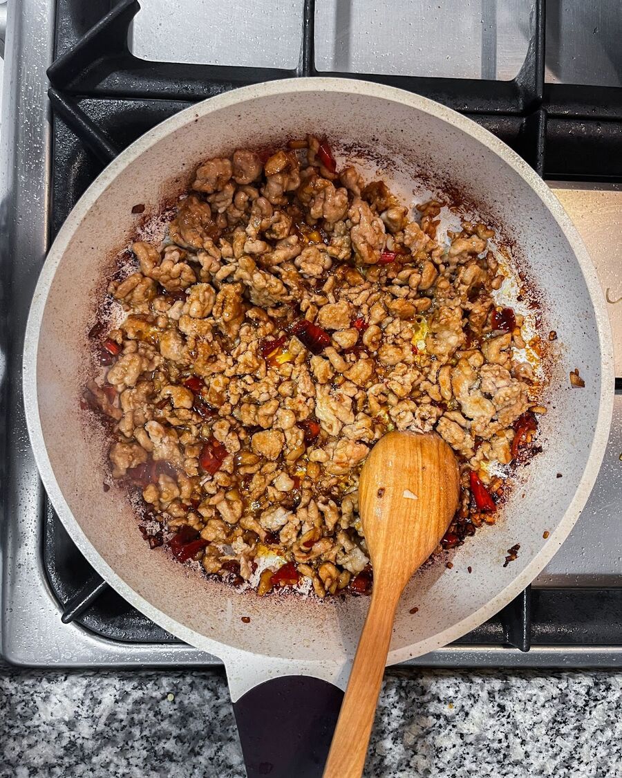 Keep stirring until the pork is evenly coated with the sauce.