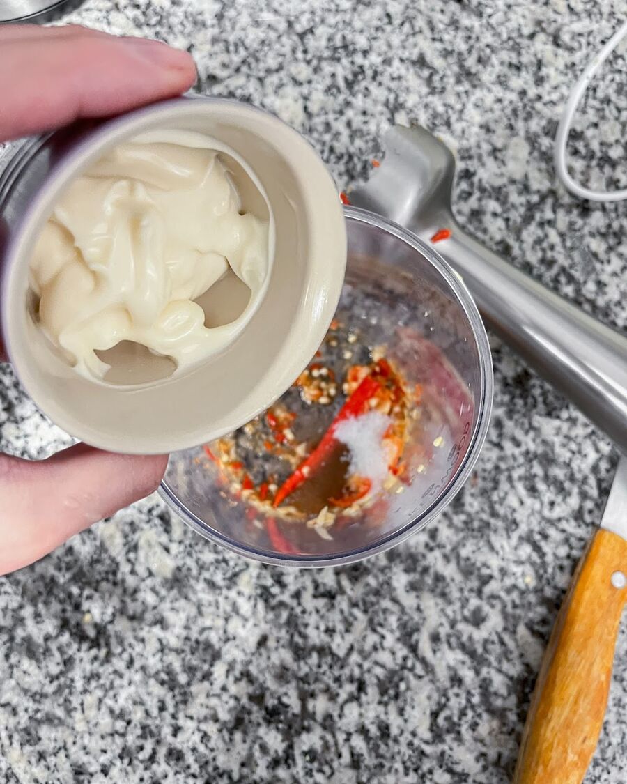 Add the sugar, fish sauce, and mayonnaise to the food processor. Process the ingredients until the mixture is smooth and well combined.