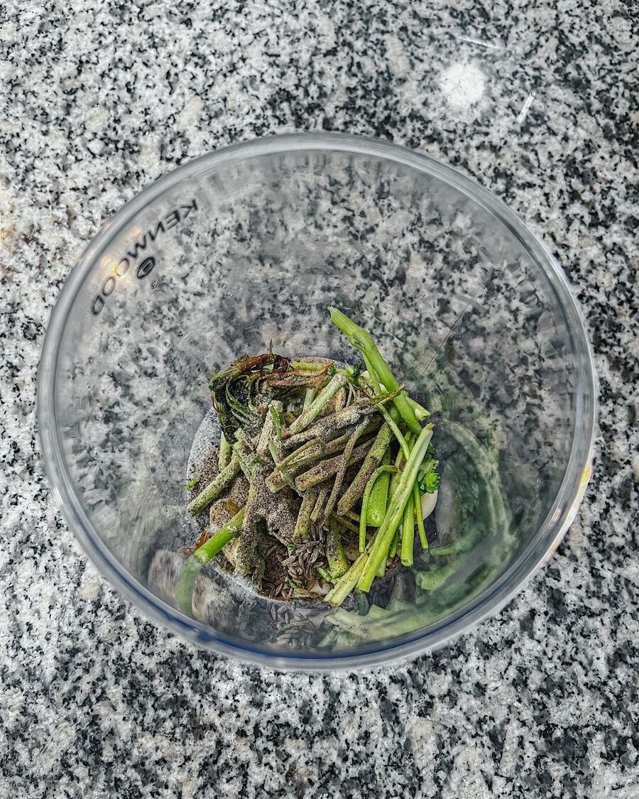 Add garlic, white and black pepper, cumin seed, salt, and carainto stem and roots to a food processor.