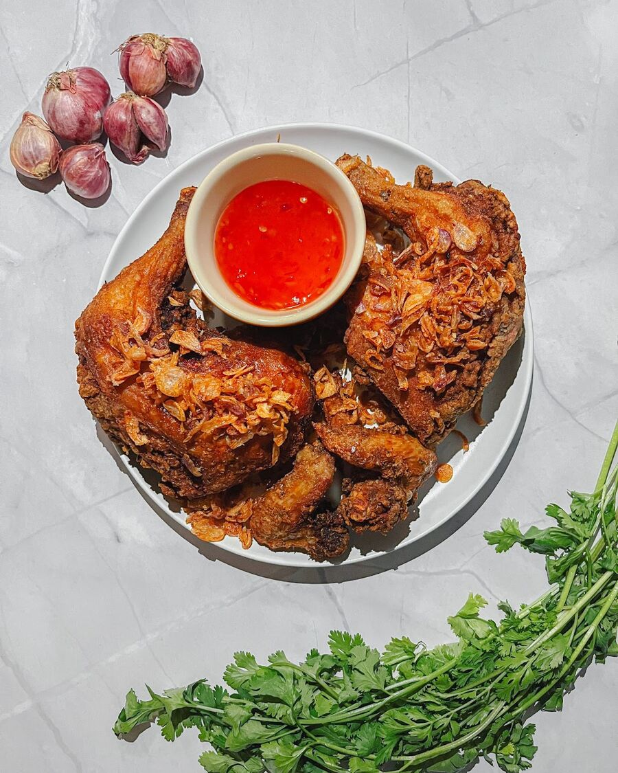 Add a fried shallot topping, and serve with sweet Thai chili sauce and sticky rice. Enjoy your meal!