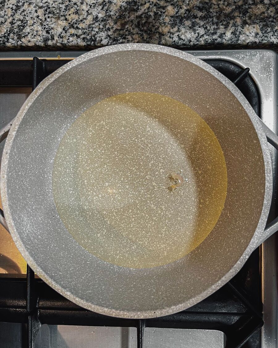 Pour oil into a saucepan or wok, just enough to barely cover the shallots. Heat the oil on medium-high heat. To test the heat, drop one piece of sliced shallot into the oil. If it starts to bubble, the oil is hot enough to add the rest of the sliced shallots.