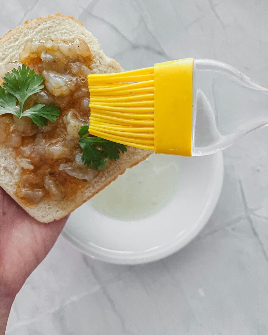 Coat the top of the shrimp mixture with beaten egg white to help it adhere to the bread.