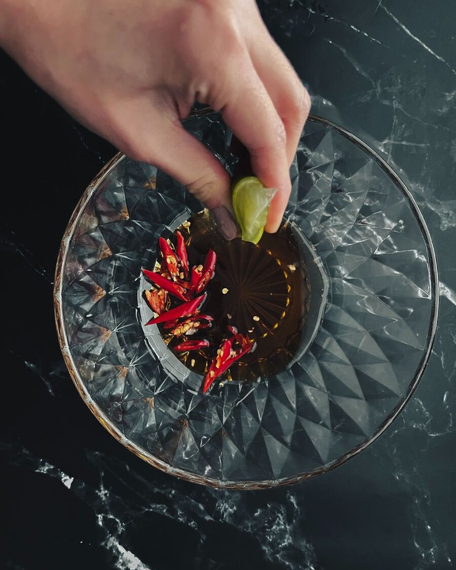 To make the salad dressing, mix palm sugar and fish sauce in a small bowl until the sugar is dissolved and then add and mix the chilis and lime juice, then set aside.