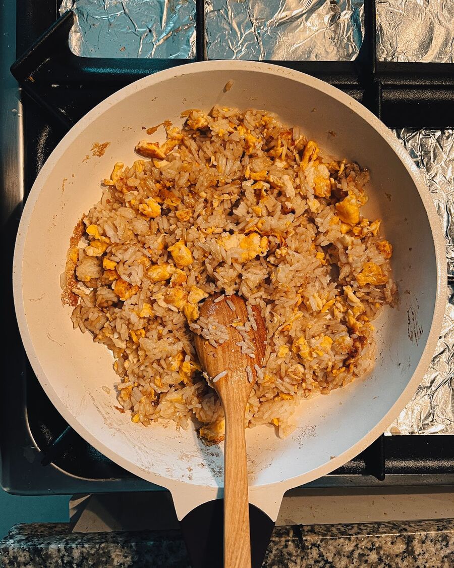 Stir-fry the rice well until it is fully coated with the sauce and turns into a golden brown fried rice.