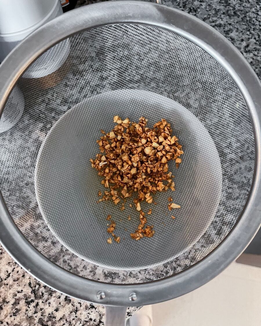 Remove the fried garlic from the pan immediately and drain off any excess oil.