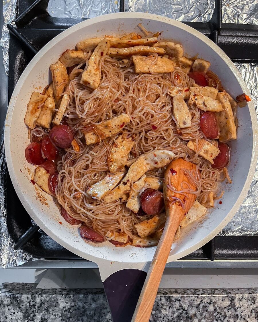 Stir the noodles and sauce together for a few minutes, until the sauce is fully coated onto the fermented rice noodles.