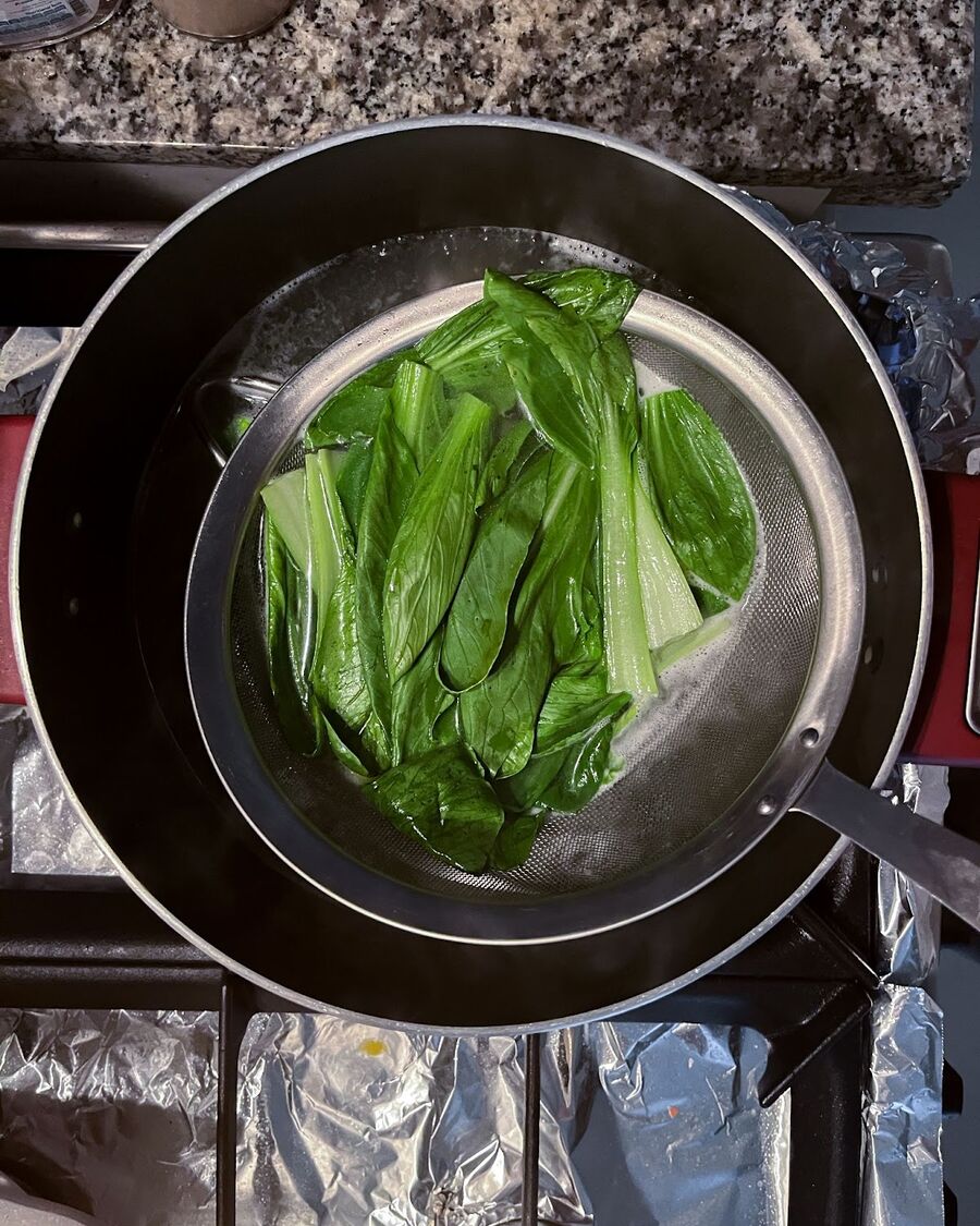 Using the same pot, blanch the bok choy for about 30 seconds. Drain the water well and move the bok choy into a serving bowl.