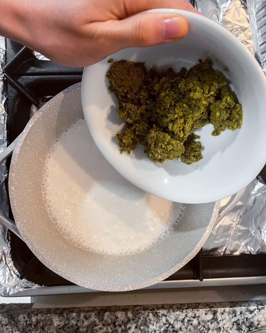 Add the green curry paste to the pot and stir until the coconut milk takes on a richer and more intense shade of green.