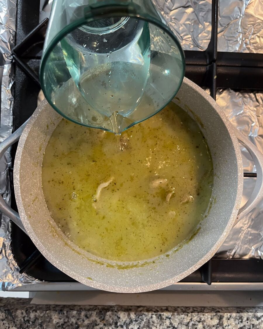 Pour water or chicken stock into the pot and stir well to ensure all the ingredients are thoroughly combined.