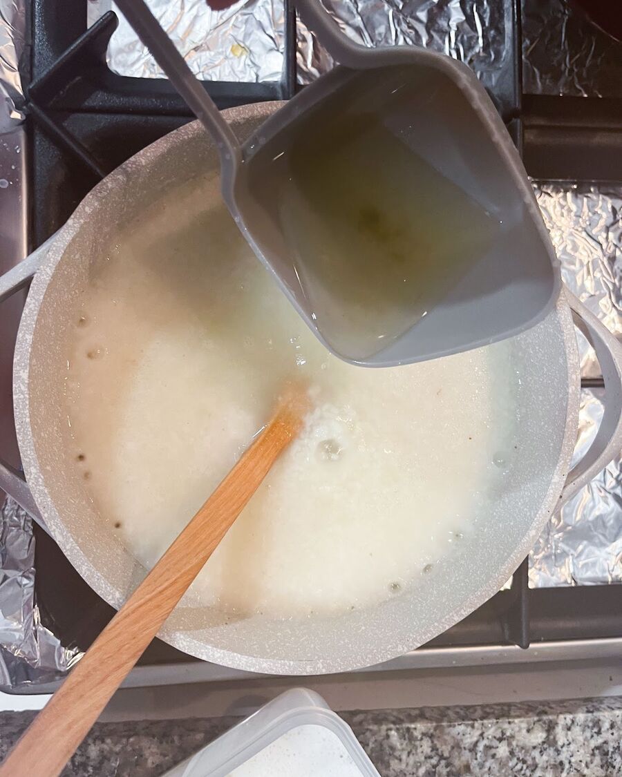 Transfer the blended rice porridge from the blender to a pot and set it on medium-low heat. Stir the porridge every 5 minutes to prevent the rice from sticking to the bottom of the pot. Gradually add chicken broth while stirring, ensuring that it blends well with the rice porridge.