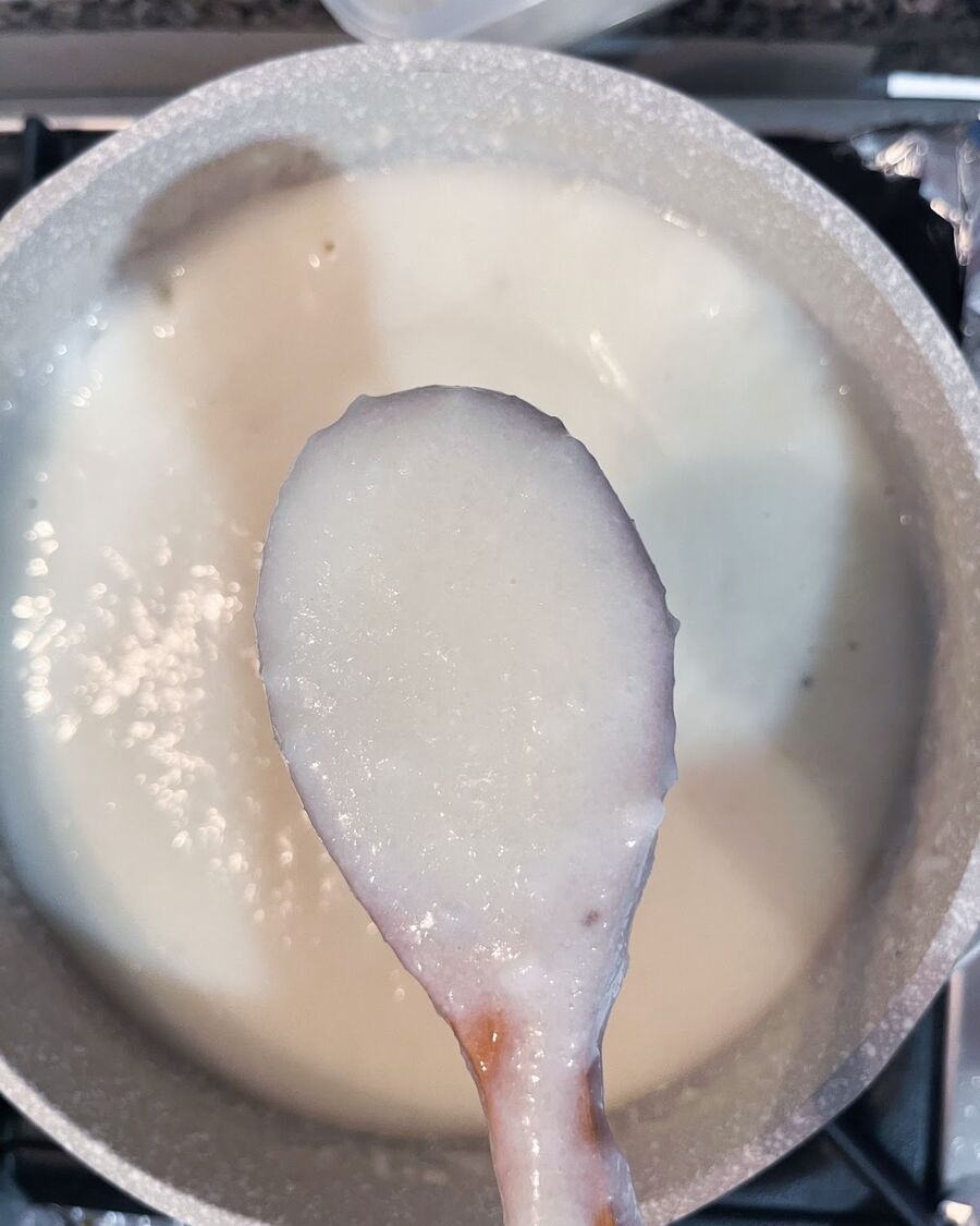 Continue stirring for about 10 minutes until the rice porridge reaches a smooth and slightly thick consistency. Shred the cooked chicken.