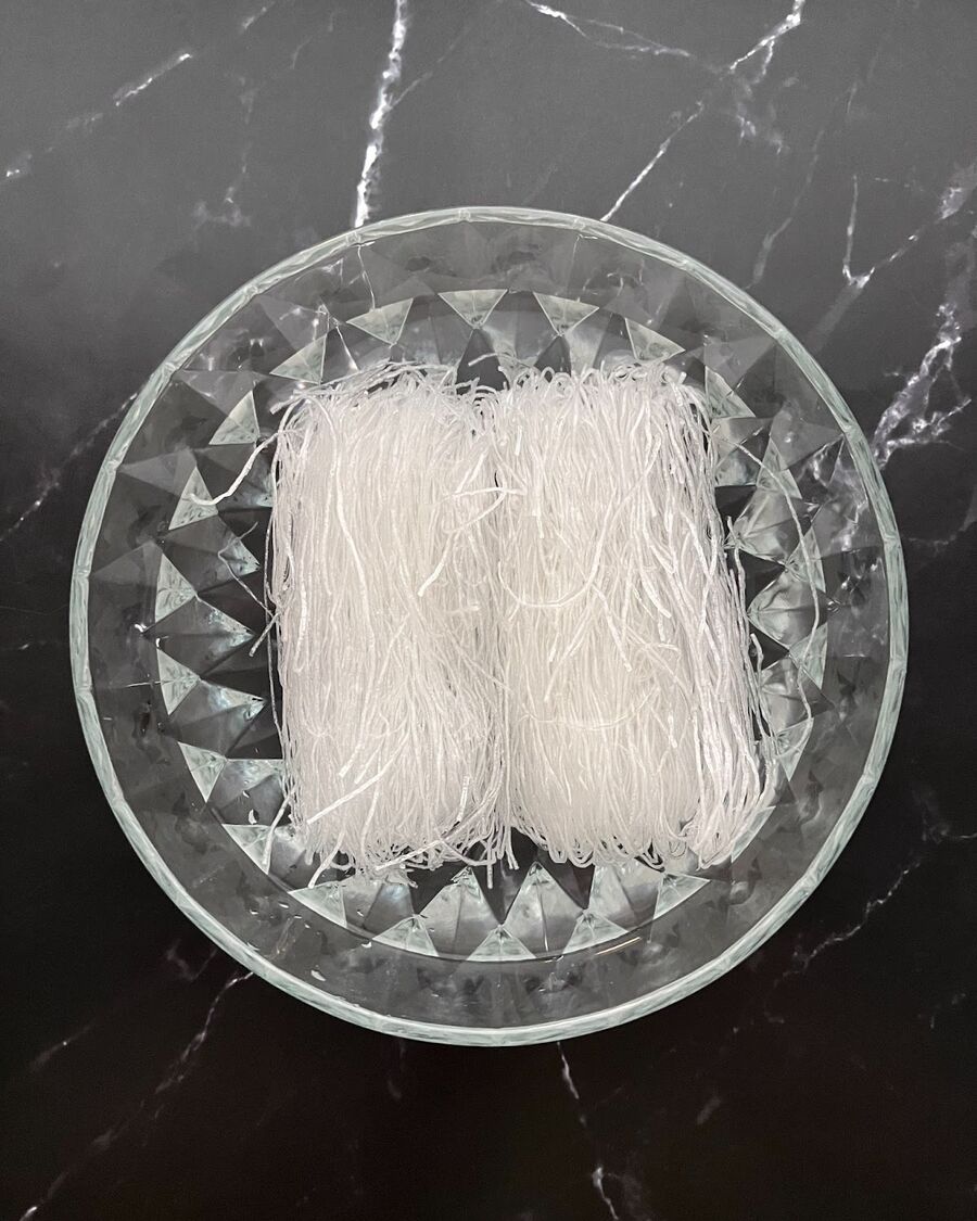 To soften the glass noodles, soak them in room temperature water for approximately 8-10 minutes or until they reach a desired softness. It is recommended to follow the instructions provided on the package for the best results.
