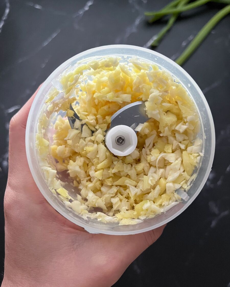 While the glass noodles are soaking, utilize a food processor to thoroughly blend ginger and garlic together.