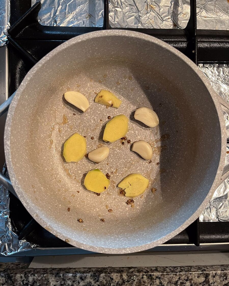 In the same pot, add 8-10 slices of ginger and a few small pieces of fatty pork.