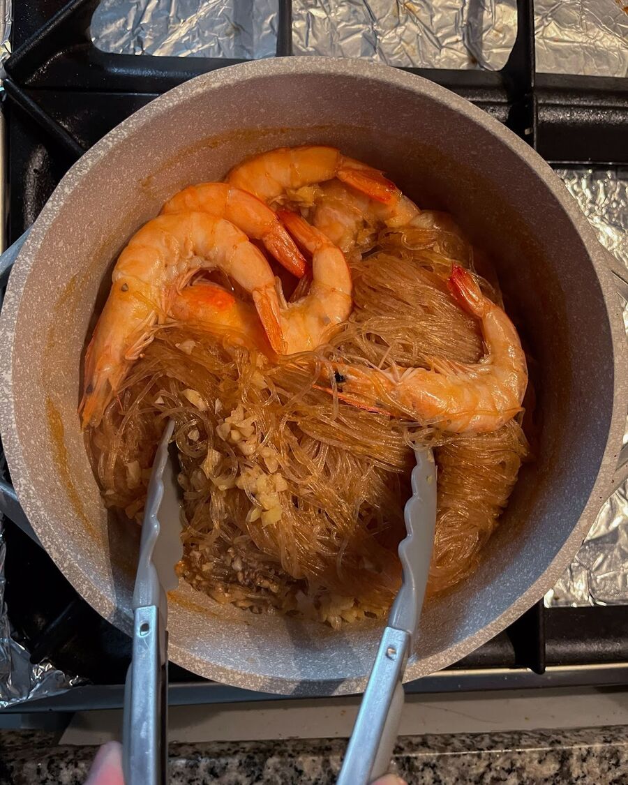 Lower the heat and carefully remove the lid and gently mix all the ingredients together, similar to tossing a salad. Allow the dish to cook without the lid for about 5 minutes, or until the sauce is no longer pooling at the bottom of the pot.
