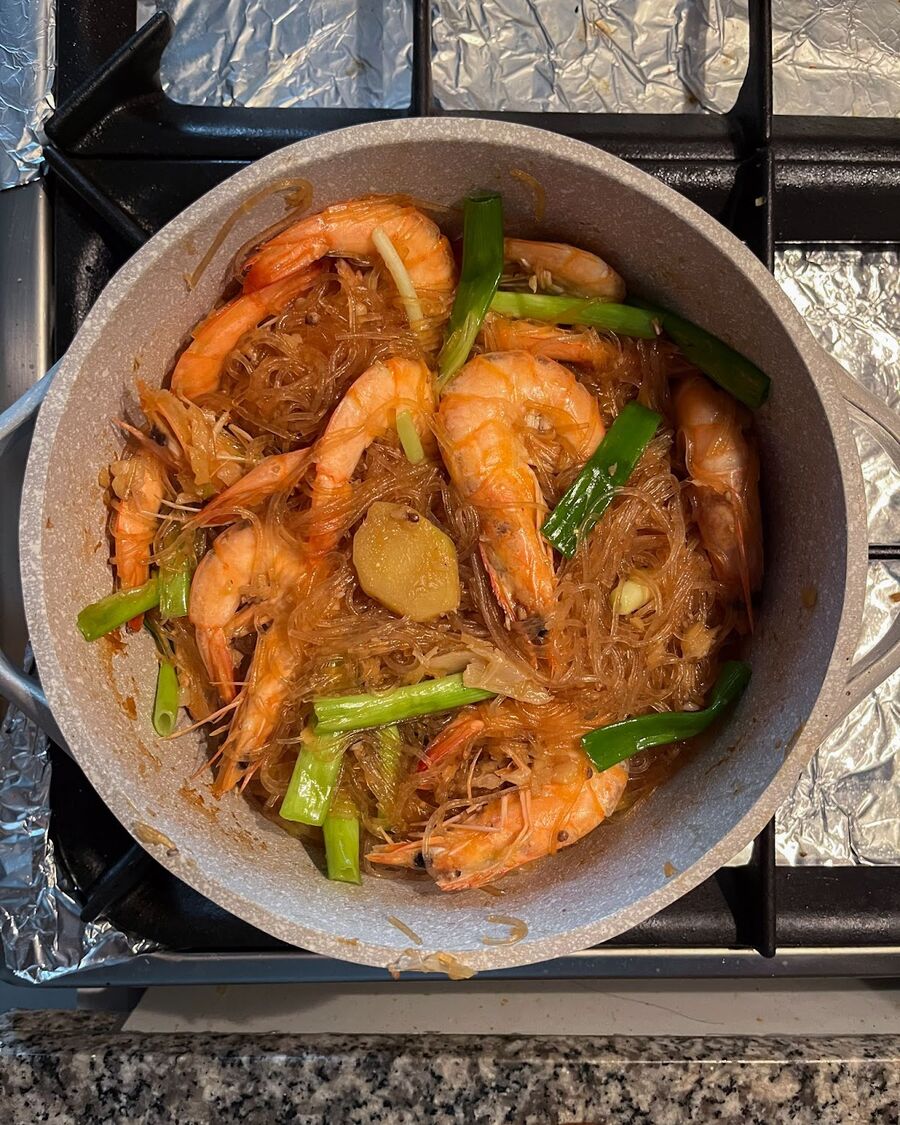 Stir the dish well, ensuring that the spring onions are evenly distributed and cooked for approximately 30 seconds until they have softened.