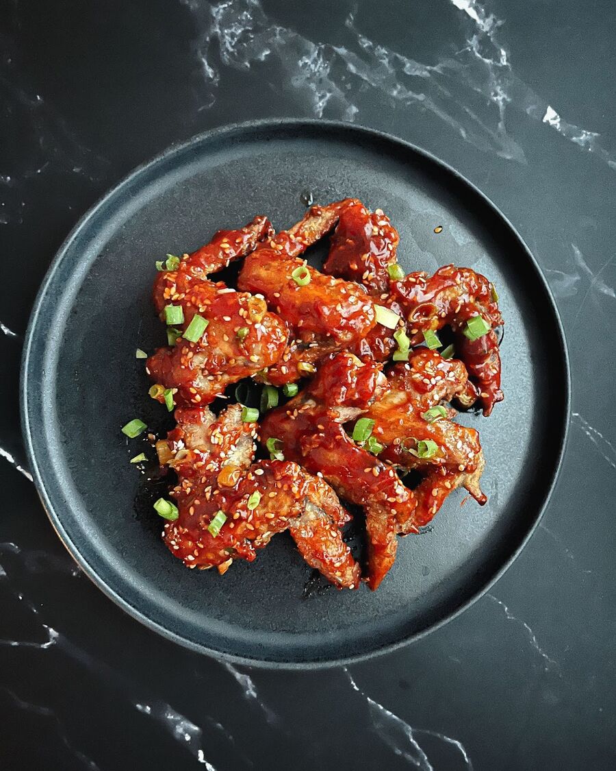 Serve and enjoy the spicy Sriracha chicken wings!