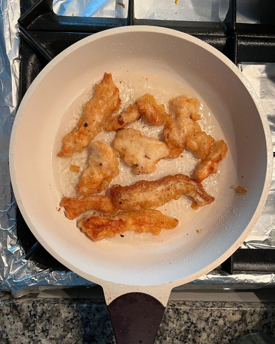 In a non-stick pan, heat some cooking oil over medium-high heat. Once the oil is hot, carefully add the chicken-flour mixture to the pan and fry them until they are well cooked.