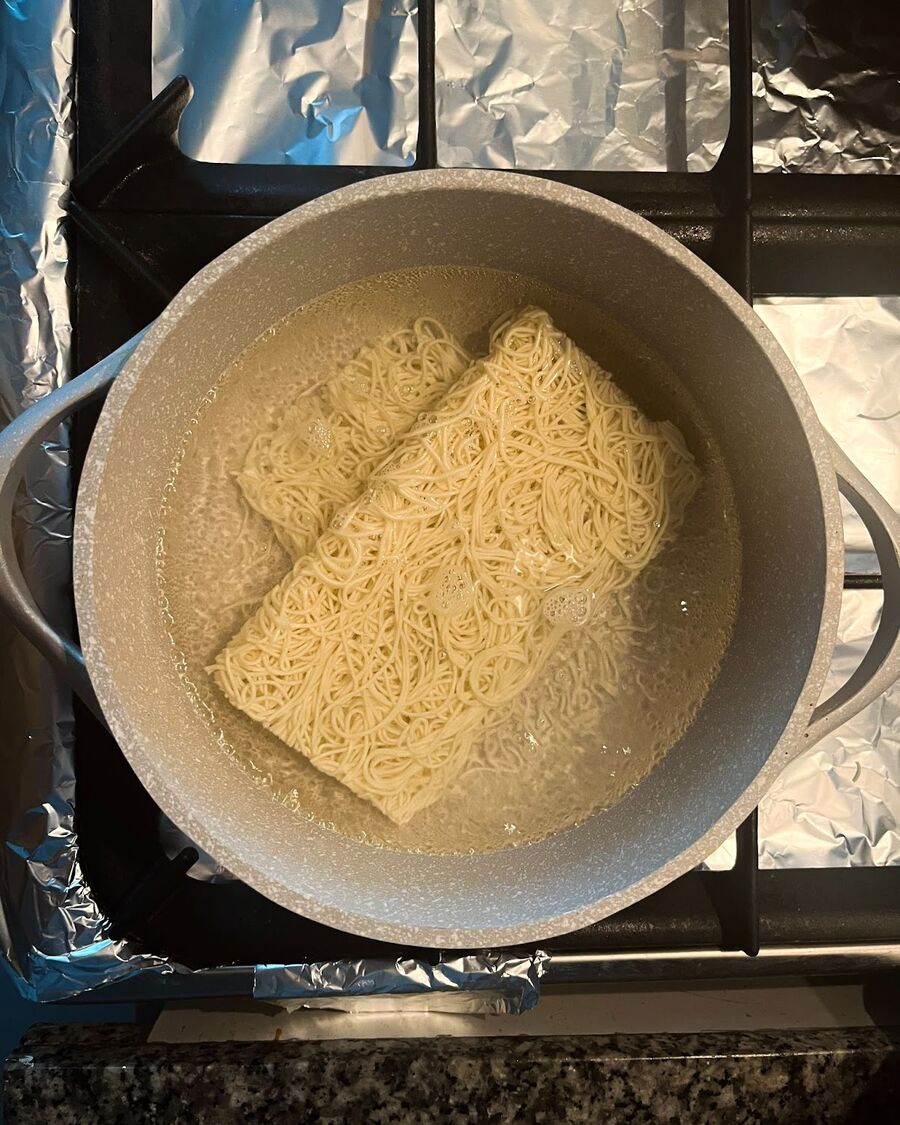 Bring a large pot of water to a boil. Cook the egg noodles until they are tender and fully cooked. Drain the noodles well and toss them with garlic oil to prevent sticking. (No matter what type of noodle you choose, be sure to carefully read the package instructions for cooking time and method).