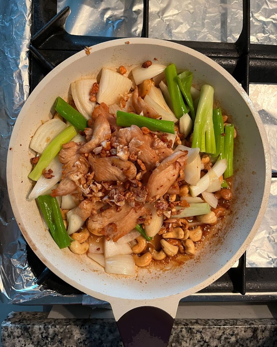 Continue stirring the ingredients and then add the fried chicken to the pan. Keep stirring everything together well.