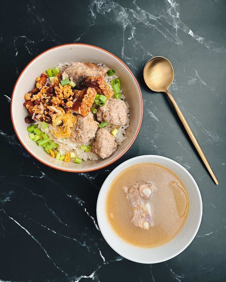 Place the warmed Jasmine rice into a bowl. Adorn the rice with pork ribs, handmade pork balls, and crispy belly pork. Garnish the dish with fried garlic, dried cabbage leaves, and spring onions. If you wish, you can also serve the flavorful soup as a side dish. Now, it's time to enjoy your homemade Phuket-style dry rice porridge, or Khao Tom Haeng!