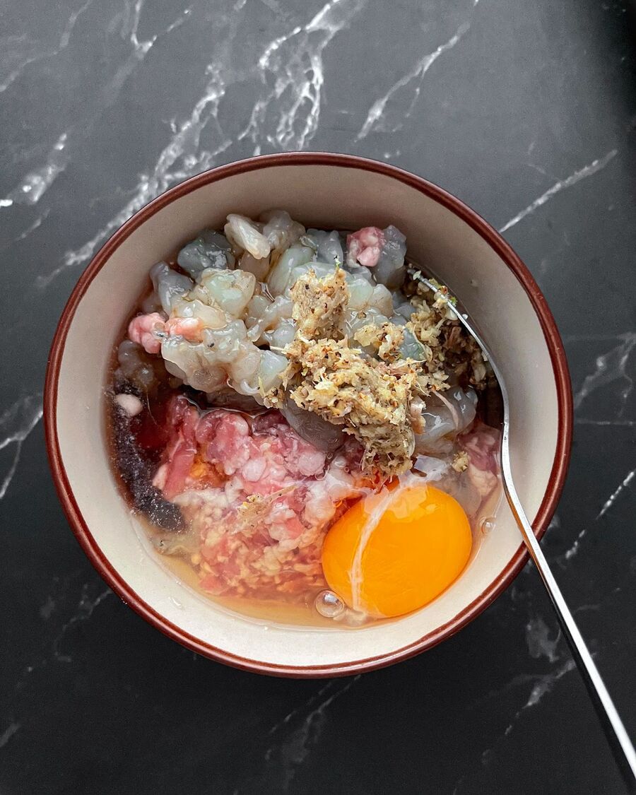 In the mixer bowl, add the diced shrimp, minced pork, minced garlic, egg, oyster sauce, and sesame oil.