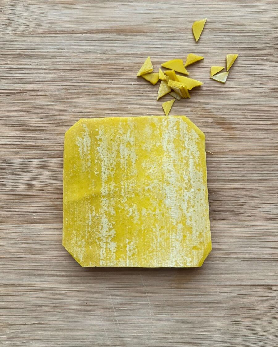 If you're using square wonton wrappers, trim off the four corners.