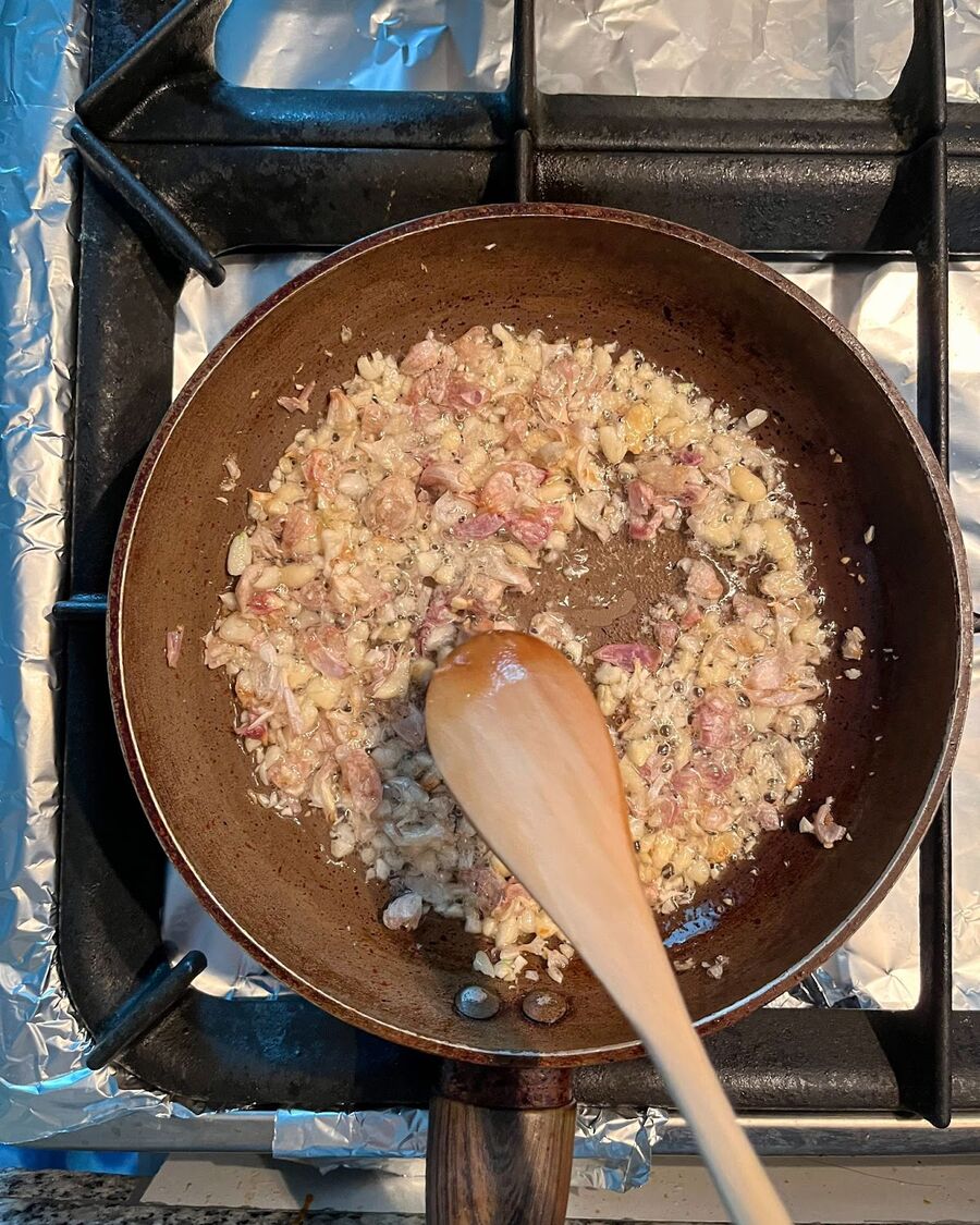 While the dumplings are steaming, take a small pan and fry the garlic. Heat ¼ cup of cooking oil over medium-high heat. Add the minced garlic and stir continuously until it turns fragrant and slightly golden. Once achieved, remove the pan from the heat.