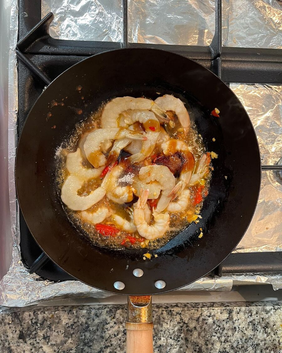 Pour in the oyster sauce, soy sauce, fish sauce, and sugar. Keep stirring and stir-fry to thoroughly combine all the ingredients.