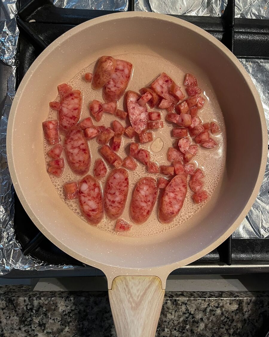 Heat a pan on medium-high heat, add ½ cup of water, and then introduce the Chinese sausage. Stir until the water has evaporated.