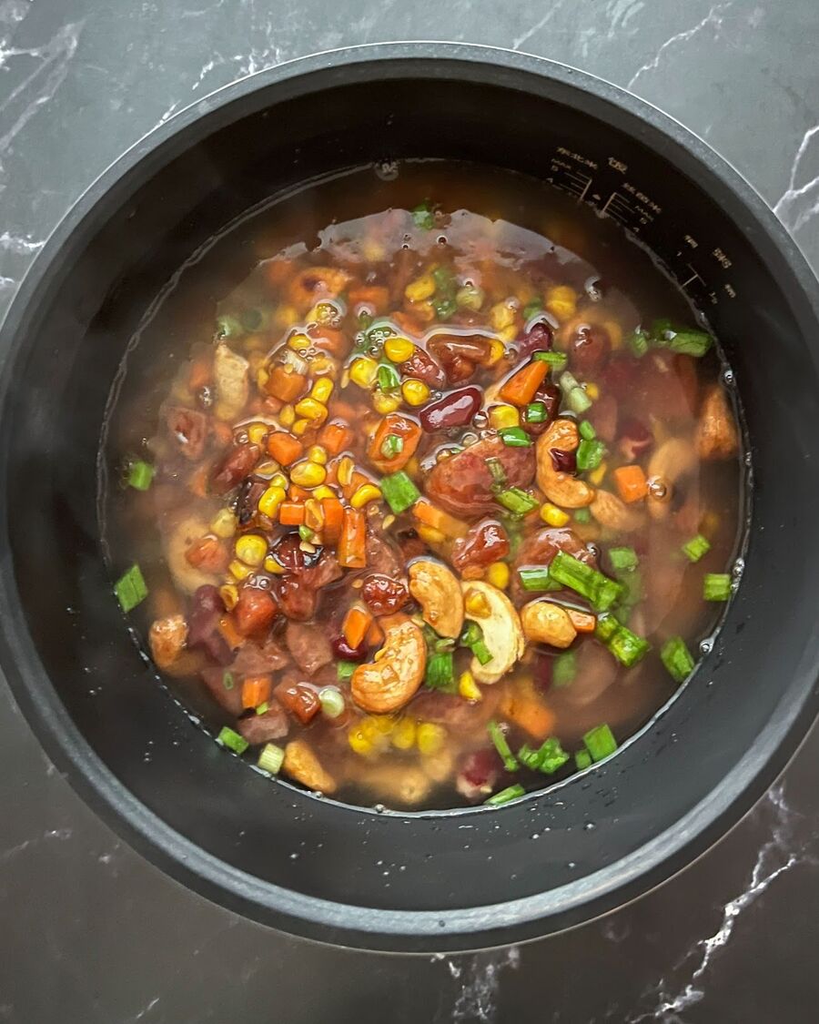 Add all the mixed ingredients from the pan into the rice cooker pot.