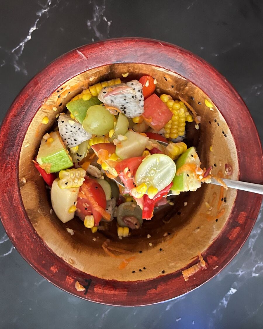 Use the spoon to assist the pestle in gently mixing the fruits.