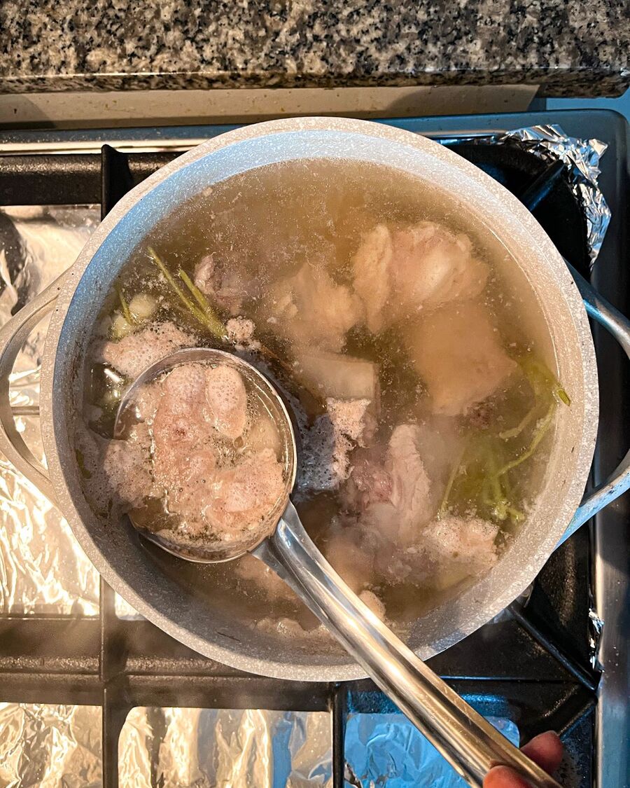 Once the soup starts to boil and bubbles appear, skim off any foam or impurities from the surface of the pot. Continue boiling the soup.