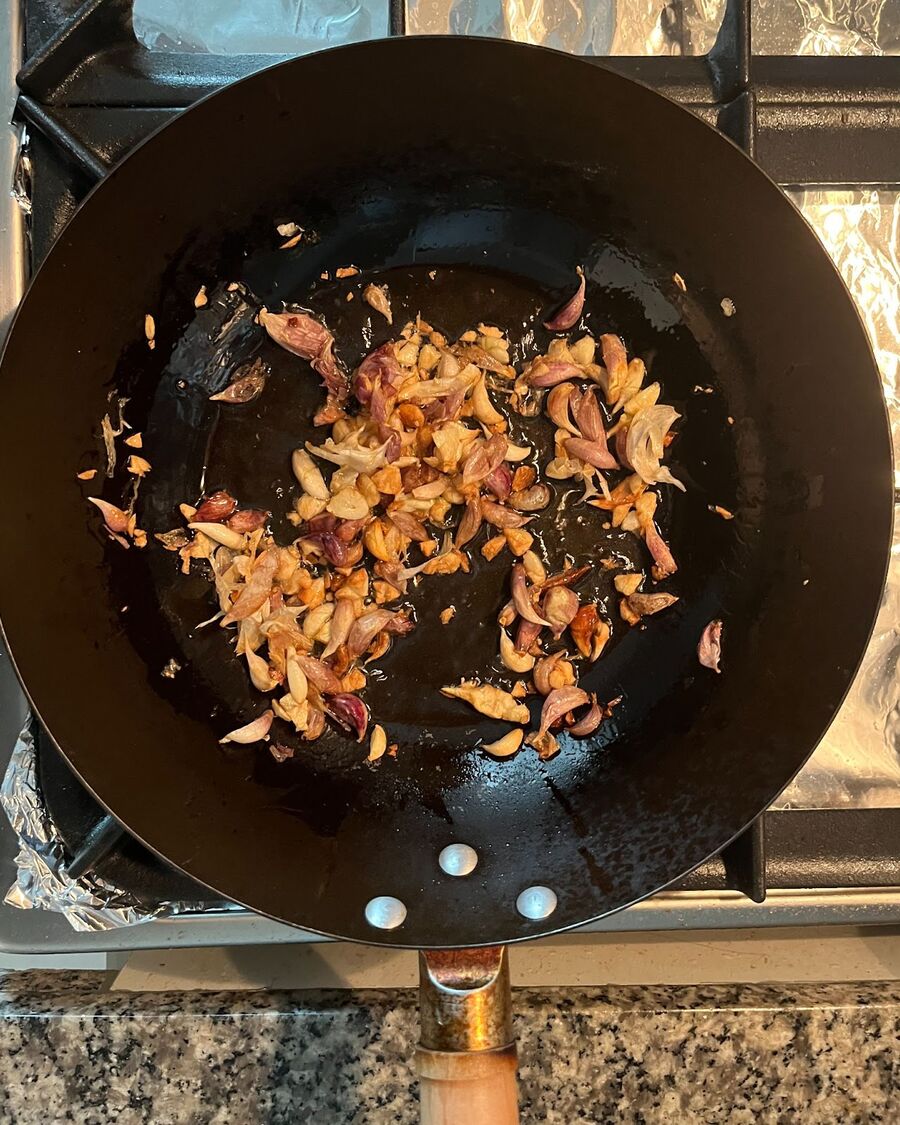 In a wok pan or frying pot, heat ¼ cup of cooking oil over medium-high heat. Add the minced garlic and stir continuously until it becomes fragrant and turns slightly golden. Once you achieve this, remove the pan from the heat.
