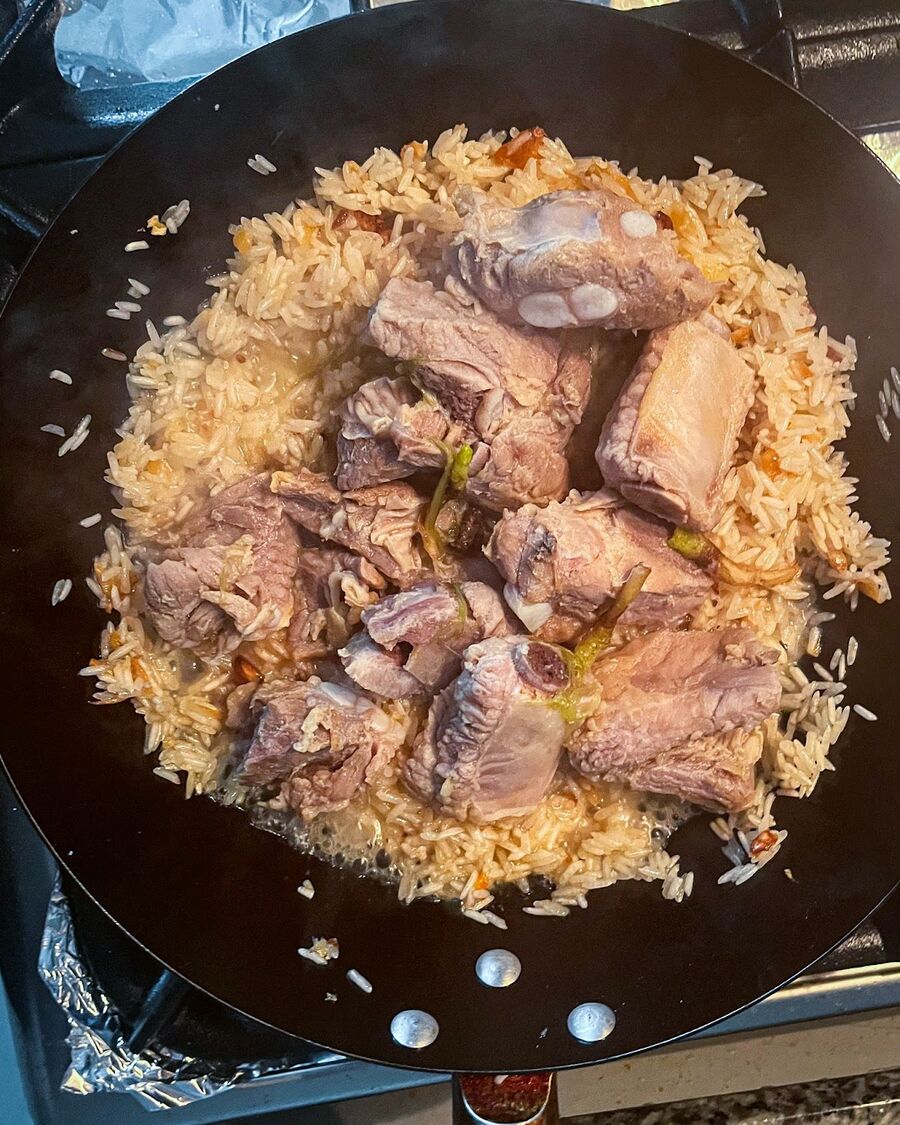 Pour the pork spare ribs and the soup over the rice. Stir and combine them for about 10 minutes, ensuring the flavors meld and the rice absorbs the delicious broth.
