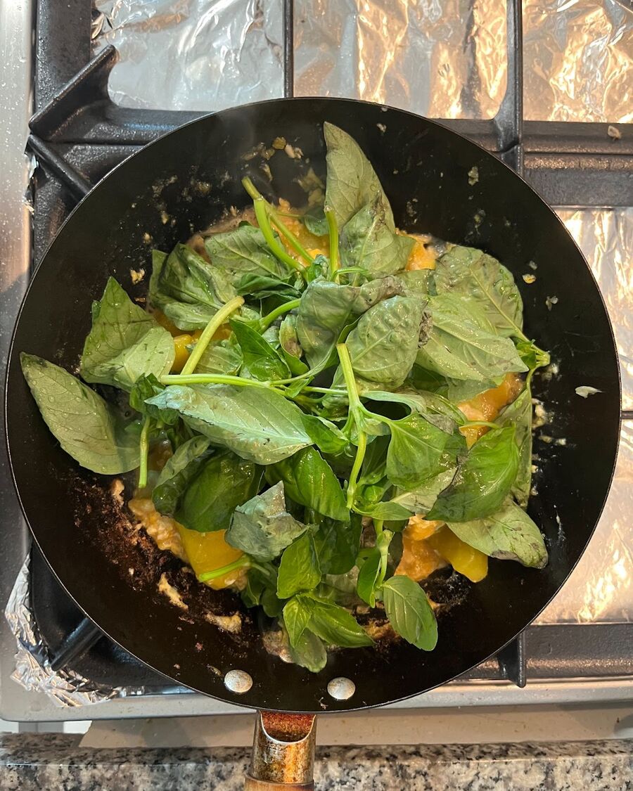 Add a handful of sweet basil over the pumpkin.