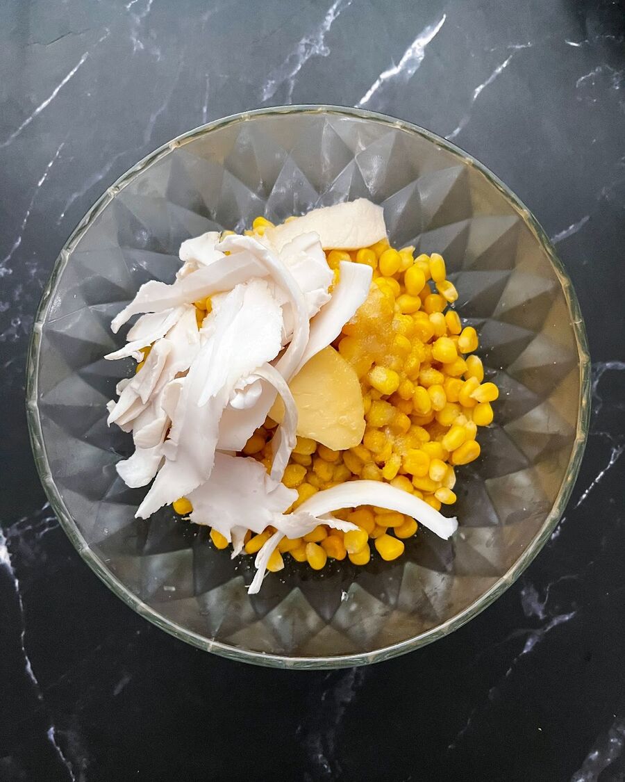 Add young coconut meat over the corn.
