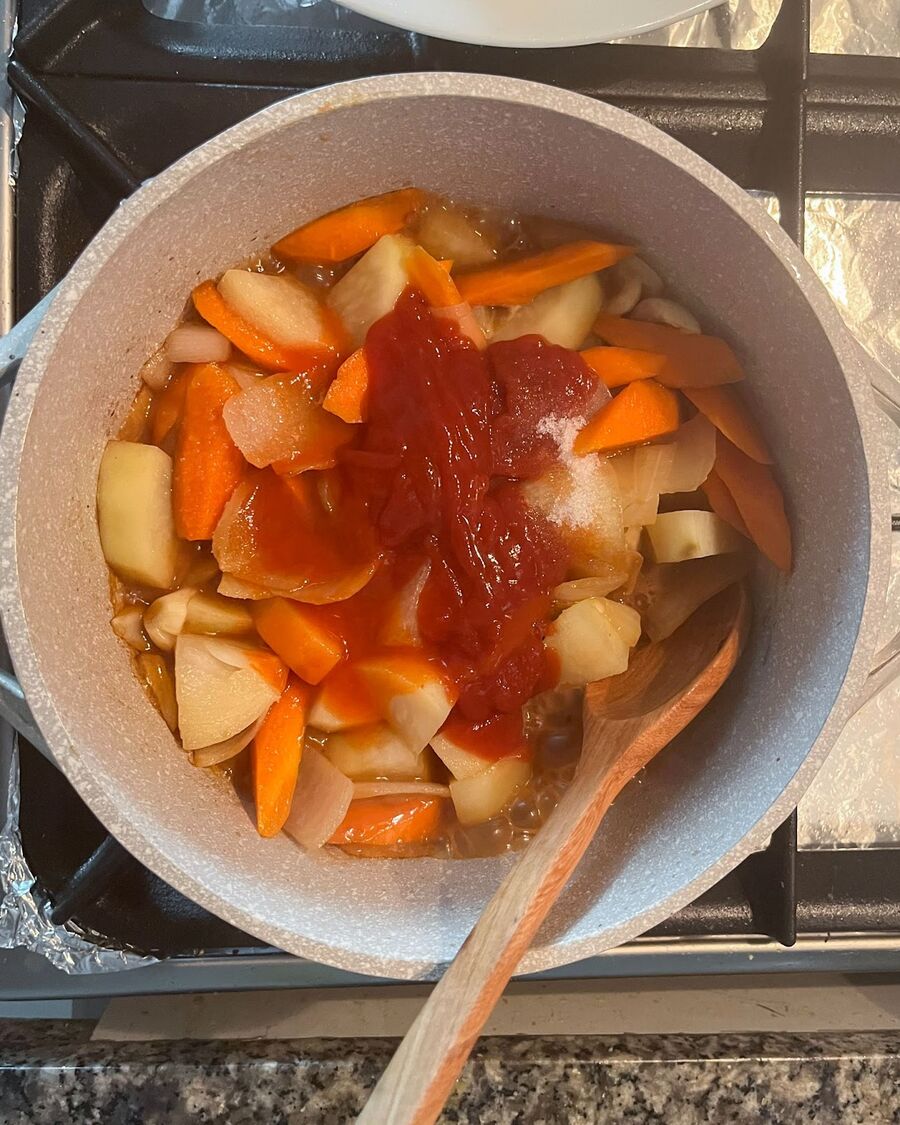 Pour in the sauce, add sugar and salt over the vegetables. Stir and combine until the vegetables are evenly coated with the sauce.