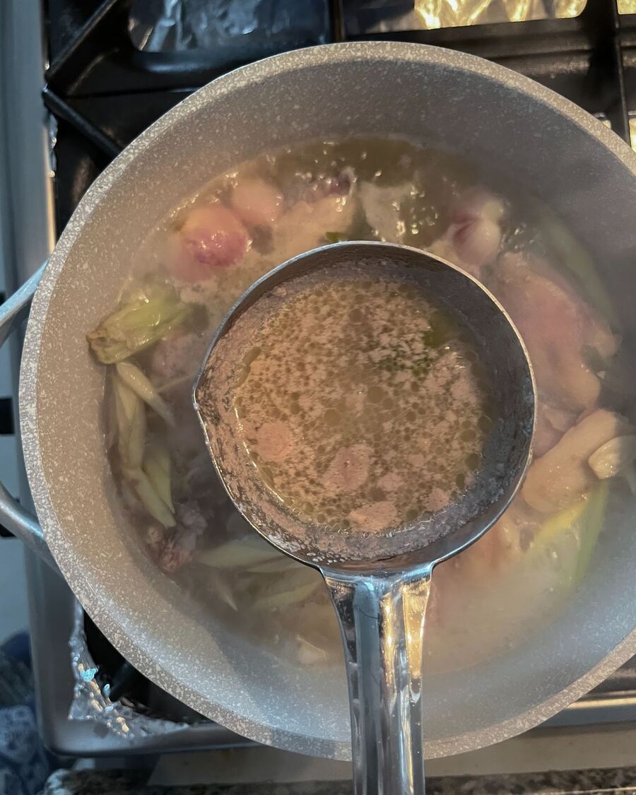Once the soup starts to boil and bubbles appear, skim off any foam or impurities from the surface of the pot. Continue boiling the soup.