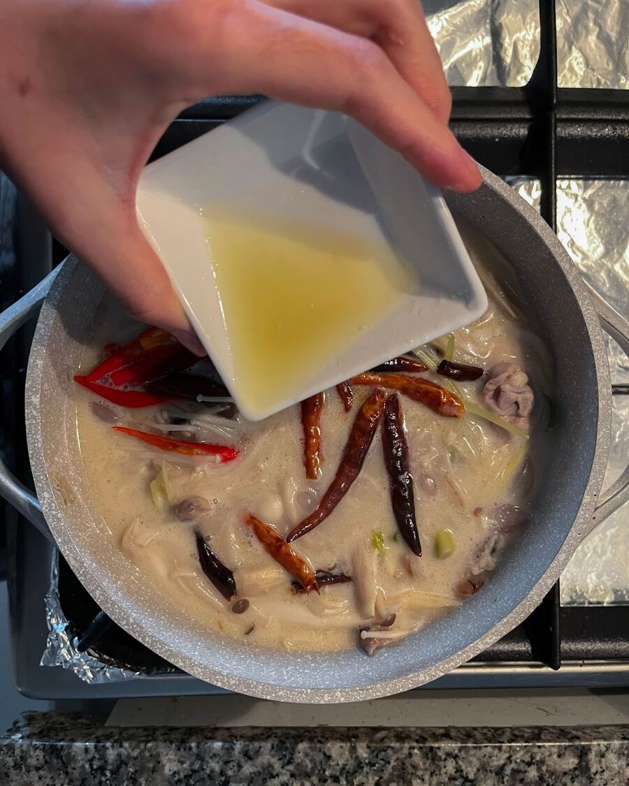 Reduce the heat and add fresh lemon juice to the soup.